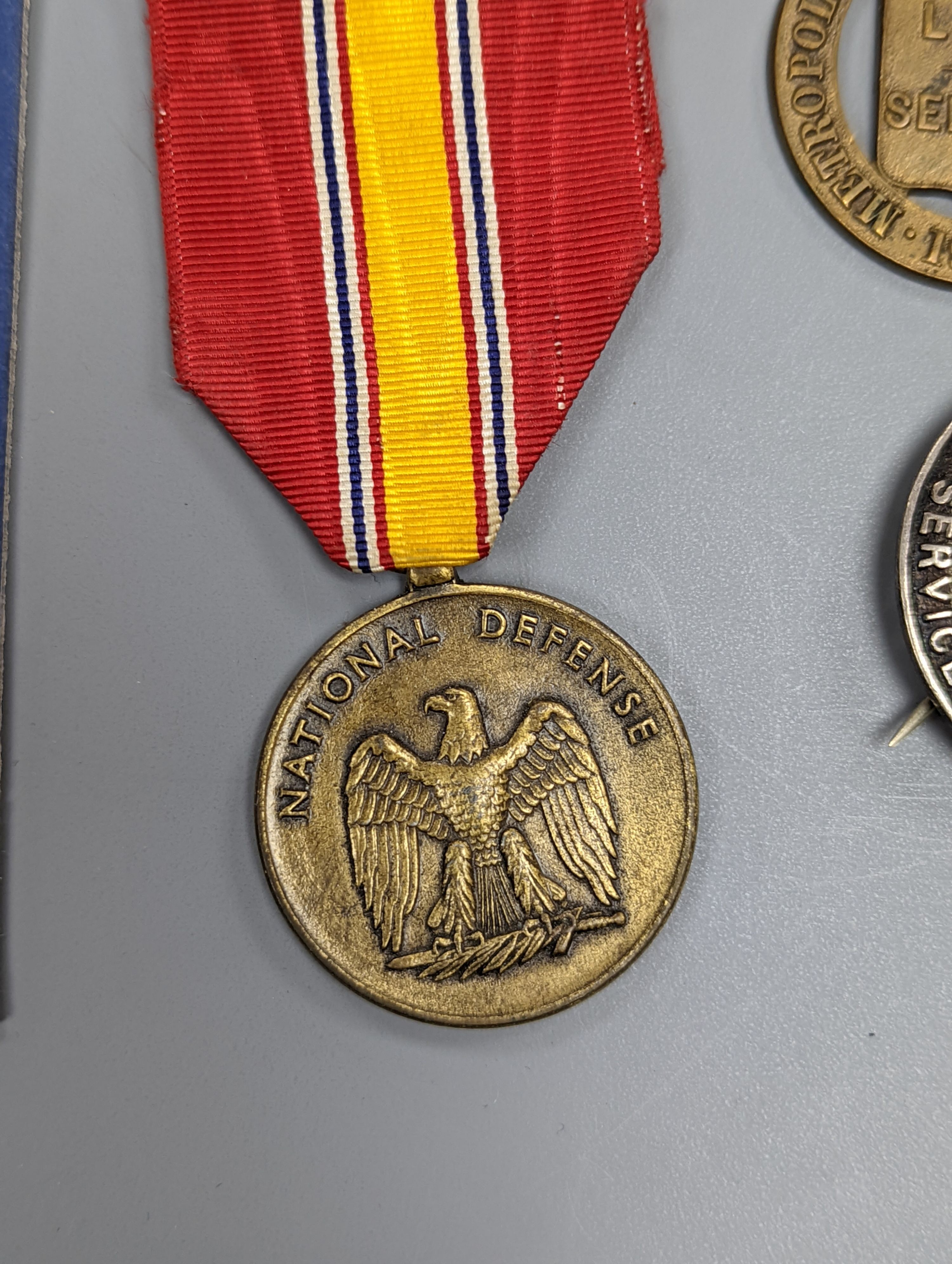 A George VI Territorial For Efficient Service medal, ARP, On War Service, Women’s Land Army badges, UN medal and other badges and medals and a quantity of reference books